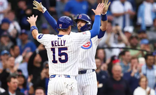 Chicago Cubs' Dansby Swanson, back, celebrates with catcher Carson Kelly (15) during the second inning of a baseball game against the Colorado Rockies in Chicago, Wednesday, June 17, 2026. (AP Photo/Jessie Alcheh)