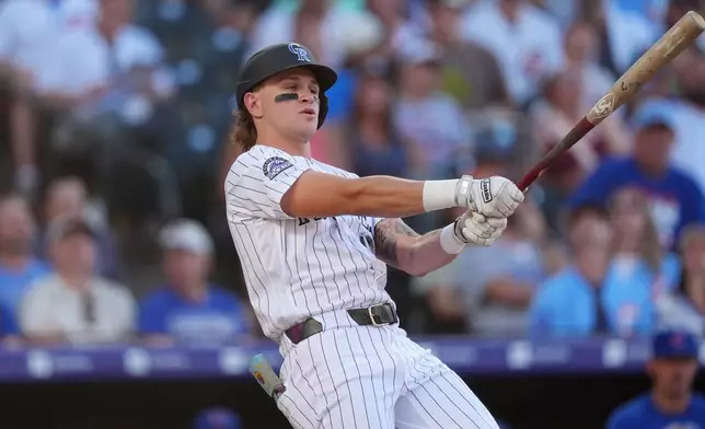 Colorado Rockies' Cole Carrigg fouls off a pitch from Chicago Cubs starting pitcher Shota Imanaga in the second inning of a baseball game, Wednesday, June 10, 2026, in Denver. (AP Photo/David Zalubowski)