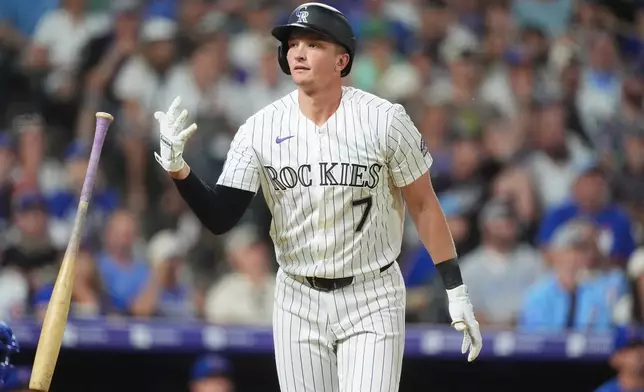 Colorado Rockies' TJ Rumfield flips his bat after connecting for a two-run home run off Chicago Cubs relief pitcher Jacob Webb in the eighth inning of a baseball game Wednesday, June 10, 2026, in Denver. (AP Photo/David Zalubowski)