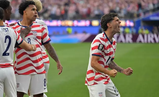 United States' Christian Pulisic, right, celebrates with teammates after an own goal by Paraguay's Damian Bobadilla during the World Cup Group D soccer match in Inglewood, Calif., near Los Angeles, Friday, June 12, 2026. (AP Photo/Jayne Kamin-Oncea)
