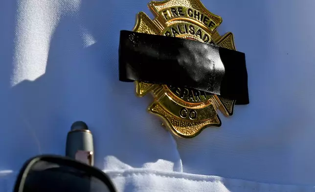 Charles Balke, of the Palisade Fire Department, wears a black band across his badge to honor three firefighters killed while fighting the Snyder Fire in Grand Junction, Colo. Sunday, June 28, 2026. (Gretel Daugherty via AP)