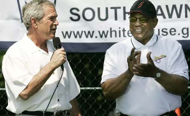 FILE - President George W. Bush, left, and National Baseball Hall of Fame member Willie Mays open the White House Tee Ball Game on the South Lawn, Sunday, July 30, 2006, in Washington. (AP Photo/Manuel Balce Ceneta, File)