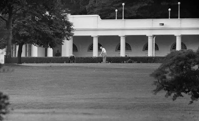 FILE - President Dwight D. Eisenhower, getting in a final bit of relaxation on the eve of the visit by Soviet Premier Nikita Khrushchev, practices a few iron shots the South Lawn of the White House in Washington, Sept. 14, 1959. (AP Photo, File)