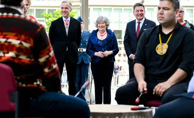 Designate Gov. Gen. Louise Arbour, centre, and Canadian Prime Minister Mark Carney look on ahead of a drum circle during her installation ceremony at the Senate of Canada in Ottawa, on Monday, June 8, 2026. (Spencer Colby/The Canadian Press via AP)