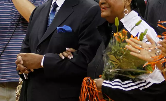 FILE - Nation of Islam Minister Louis Farrakhan and his wife, Khadijah, watch as their grandson, Virginia senior Mustapha Farrakhan, is honored with other seniors before Virginia's NCAA college basketball game against North Carolina State in Charlottesville, Va., Tuesday, March 1, 2011. (AP Photo/Steve Helber, File)