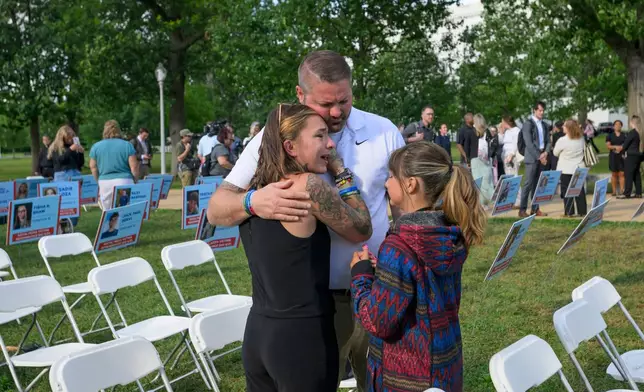 Brittney Bird, from left, is comforted by her husband Luke Bird and daughter Aurora Bird as they remember her son Bradyn Bohn, 15, during a Social Media Victims Remembrance Day memorial on Capitol Hill, Tuesday, June 23, 2026, in Washington. (AP Photo/Rod Lamkey, Jr.)