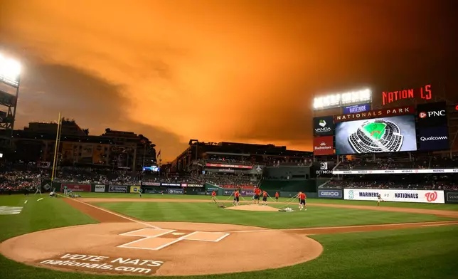The Washington Nationals grounds crew prepares the field before a baseball game between the Washington Nationals and the Seattle Mariners, Friday, June 12, 2026, in Washington. (AP Photo/Nick Wass)