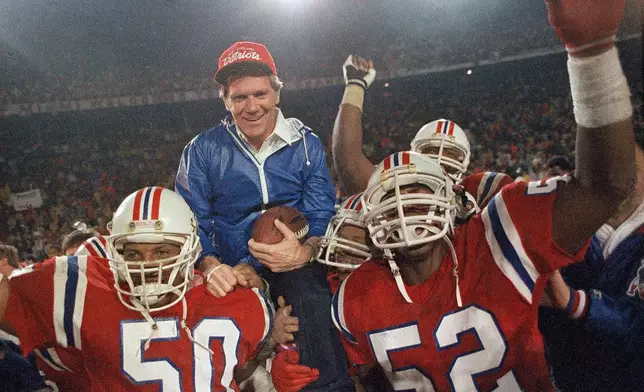 FILE - IN this Jan. 12, 1986, file photo, New England Patriots coach Raymond Berry gets a victory ride from players Larry McGrew (50) and Johnny Rembert (52) after the Patriots defeated the Miami Dolphins 31-14 in the NFL football AFC playoffs in Miami. (AP Photo/File)