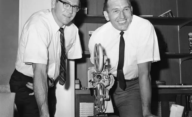 FILE - Baltimore Colts quarterback Johnny Unitas and veteran split end Raymond Berry, left, review films of previous Colt games in Baltimore on Oct. 25, 1967. (AP Photo/William Smith, file)