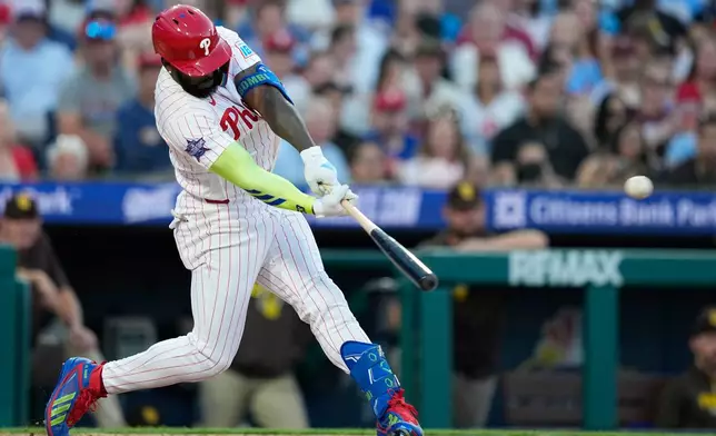 Philadelphia Phillies' Adolis García hits a run-scoring double against San Diego Padres pitcher Walker Buehler during the fifth inning of a baseball game Wednesday, June 3, 2026, in Philadelphia. (AP Photo/Matt Slocum)