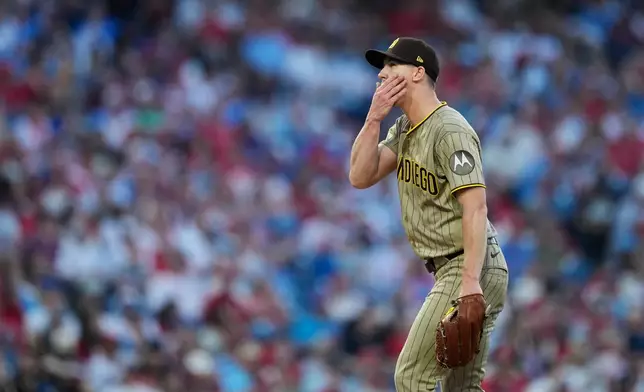 San Diego Padres' Walker Buehler wipes his face while pitching against Philadelphia Phillies' Trea Turner during the fifth inning of a baseball game Wednesday, June 3, 2026, in Philadelphia. (AP Photo/Matt Slocum)