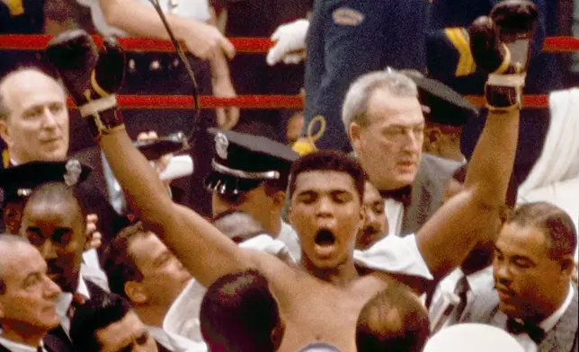 FILE - In this Feb. 25, 1964, file photo, Muhammad Ali, or Cassius Clay at the time, strikes a familiar pose as he shouts "I am the greatest," as he leaves the ring, arms raised, following his defeat of former heavyweight boxing champion Sonny Liston, in Miami Beach, Fla. (AP Photo/File)