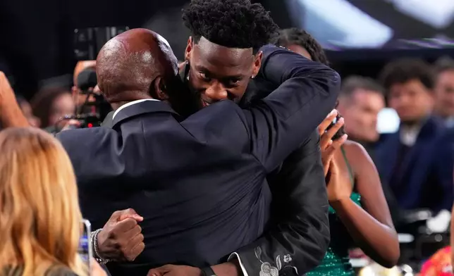 AJ Dybantsa, right, celebrates after being chosen by the Washington Wizards as the first pick in the first round of the NBA basketball draft, Tuesday, June 23, 2026, in New York. (AP Photo/Yuki Iwamura)