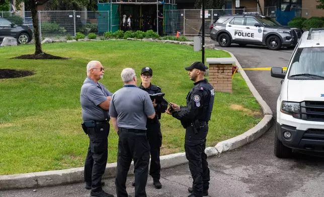 Investigators work the scene where a Toronto Police officer was shot in Toronto on Thursday, June 11, 2026. (Arlyn McAdorey/The Canadian Press via AP)
