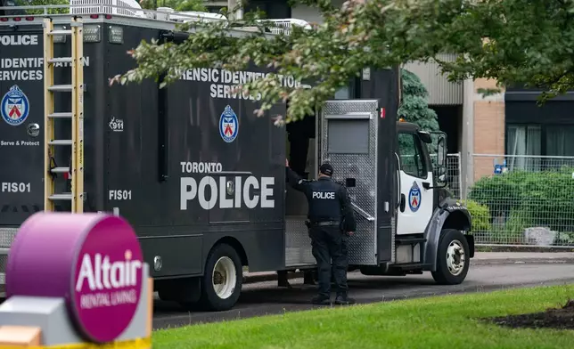 Investigators work the scene where a Toronto Police officer was shot in Toronto on Thursday, June 11, 2026. (Arlyn McAdorey/The Canadian Press via AP)