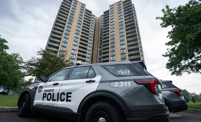 Investigators work the scene where a Toronto Police officer was shot in Toronto on Thursday, June 11, 2026. (Arlyn McAdorey/The Canadian Press via AP)