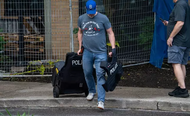 Investigators work the scene where a Toronto Police officer was shot in Toronto on Thursday, June 11, 2026. (Arlyn McAdorey/The Canadian Press via AP)