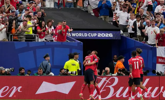 England's Harry Kane (9) celebrates scoring their second goal with Jude Bellingham (10) during the World Cup Group L soccer match between Panama and England in East Rutherford, N.J., near New York, Saturday, June 27, 2026. (AP Photo/Seth Wenig)