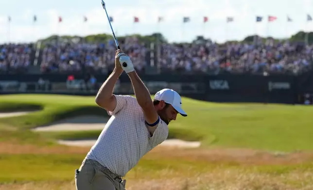Scottie Scheffler hits his tee shot on the 17th hole during the third round of the U.S. Open golf tournament at Shinnecock Hills Golf Club in Southampton, N.Y., Saturday, June 20, 2026.(AP Photo/David J. Phillip)