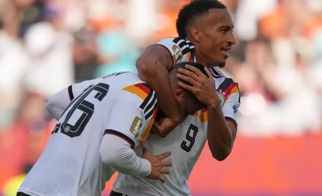 Germany's Deniz Undav, left, celebrates with teammate Germany's Jamie Leweling after scoring their first goal during the World Cup Group E soccer match between Germany and Ivory Coast in Toronto, Saturday, June 20, 2026. (AP Photo/Stephanie Scarbrough)