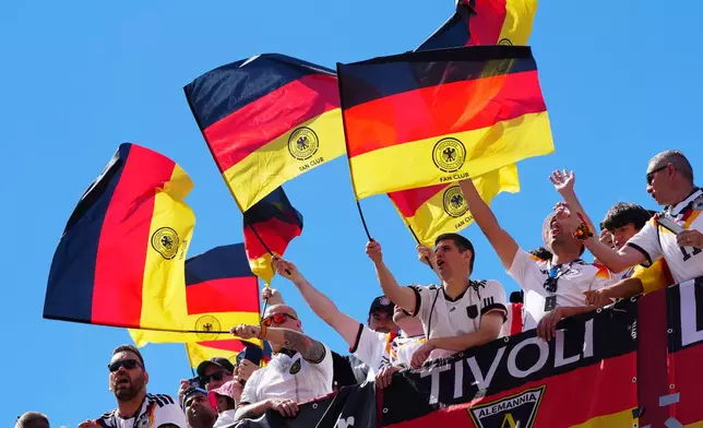 Germany fans sing their national anthem and wave flags before the World Cup Group E soccer match between Germany and Ivory Coast in Toronto, Saturday, June 20, 2026. (Frank Gunn/The Canadian Press via AP)