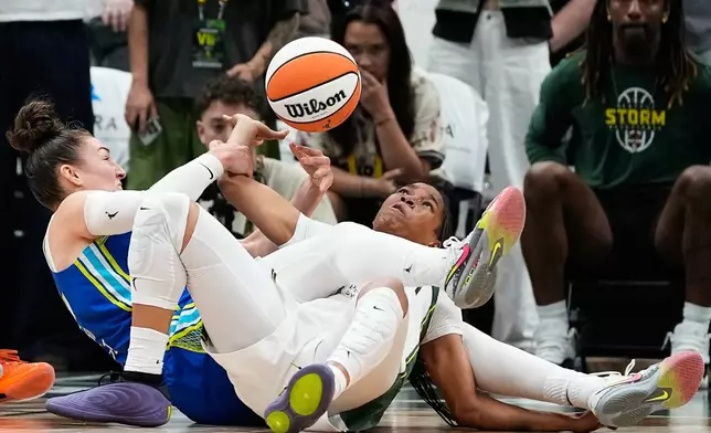 Dallas Wings forward Jessica Shepard and Seattle Storm guard Zia Cooke struggle for the ball during overtime in a WNBA basketball game, Monday, June 22, 2026, in Seattle. (AP Photo/Lindsey Wasson)