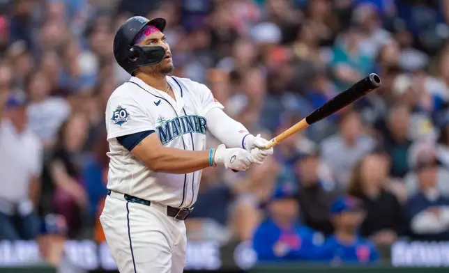 Seattle Mariners' Josh Naylor watches his solo home run during the seventh inning of a baseball game against the New York Mets, Monday, June 1, 2026, in Seattle. (AP Photo/Stephen Brashear)