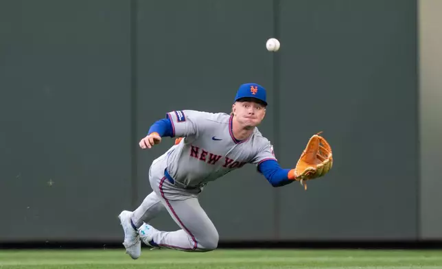New York Mets centerfielder A.J. Ewing makes a diving catch during the fifth inning of a baseball game against the Seattle Mariners, Monday, June 1, 2026, in Seattle. (AP Photo/Stephen Brashear)