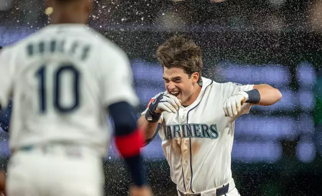 Seattle Mariners' Cole Young celebrates after a baseball game against the New York Mets, Monday, June 1, 2026, in Seattle. (AP Photo/Stephen Brashear)