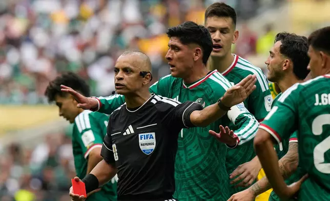 Mexican players complain to referee Wilton Sampaio, of Brazil, after he showed the red card Mexico's Cesar Montes during the World Cup Group A soccer match between Mexico and South Africa in Mexico City, Thursday, June 11, 2026. (AP Photo/Fernando Llano)