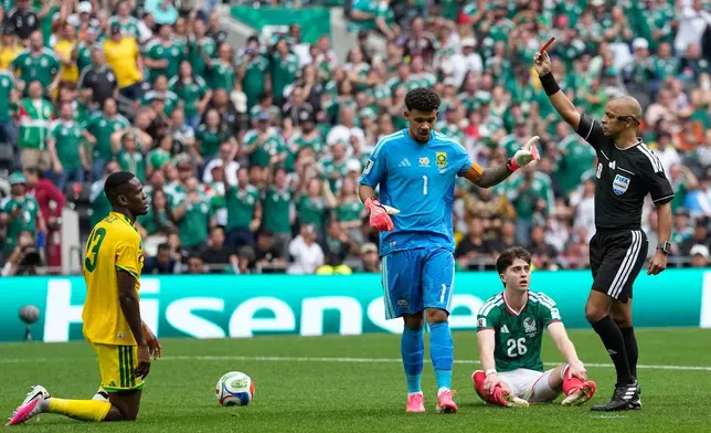 Referee Wilton Sampaio a red card to South Africa's Sphephelo Sithole, left, during the World Cup Group A soccer match between Mexico and South Africa in Mexico City, Thursday, June 11, 2026. (AP Photo/Natacha Pisarenko)