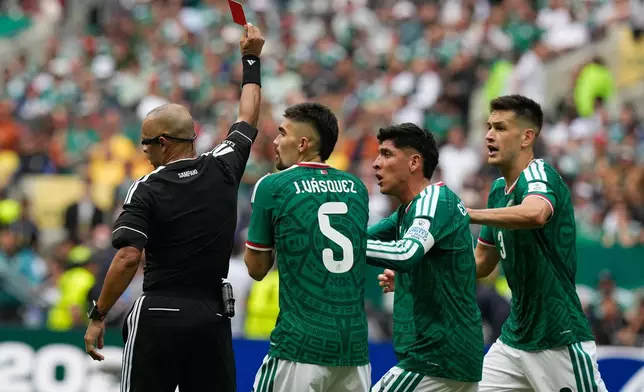 Referee Wilton Sampaio, of Brazil, sends off Mexico's Cesar Montes, right, during the World Cup Group A soccer match between Mexico and South Africa in Mexico City, Thursday, June 11, 2026. (AP Photo/Fernando Llano)
