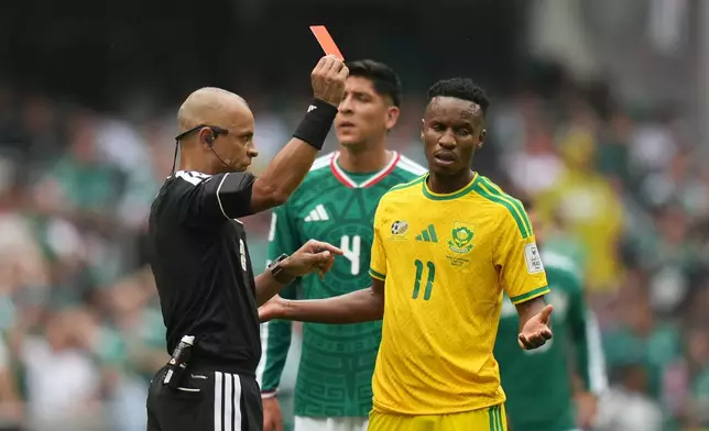 Referee Wilton Sampaio, of Brazil, show the red card to South Africa's Themba Zwane during the World Cup Group A soccer match between Mexico and South Africa in Mexico City, Thursday, June 11, 2026. (AP Photo/Silvia Izquierdo)