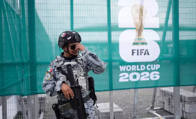 A National Guard officer stands guard outside a stadium that will host FIFA World Cup matches in Guadalajara, Mexico, Tuesday, June 9, 2026. (AP Photo/Matias Delacroix)