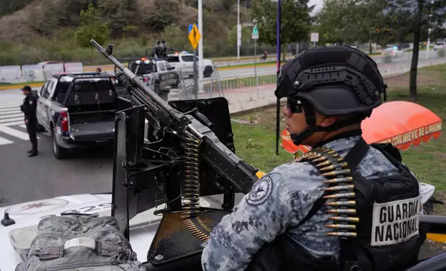 National Guard stand on guard outside the stadium that will host FIFA World Cup matches in Guadalajara, Mexico, Tuesday, June 9, 2026. (AP Photo/Matias Delacroix)