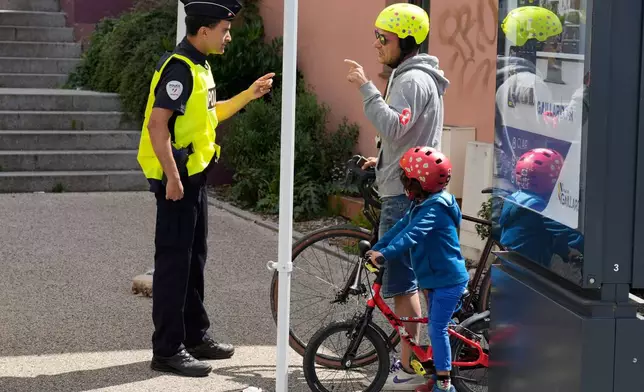 French police officers check people crossing the border between Geneva and the French town of Gaillard, France, Wednesday, June 10, 2026, ahead of the upcoming G7 summit due to take place June 15-17 in the town of Evian-les-Bains. (AP Photo/Baz Ratner)