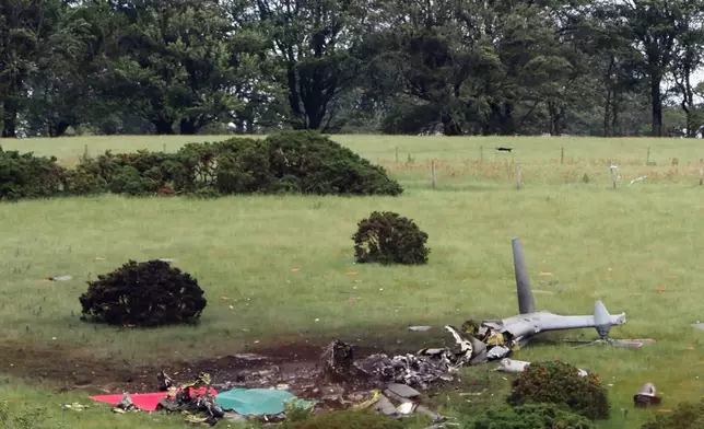 The scene in Sourton Down, near Okehampton in Devon, where a Royal Navy helicopter crashed in a field, England, Wednesday, June 3, 2026. (PA via AP)