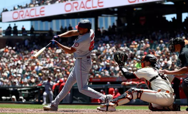 Washington Nationals' James Wood, left, hits a two-run home run in front of San Francisco Giants catcher Daniel Susac, right, during the third inning of a baseball game in San Francisco, Wednesday, June 10, 2026. (AP Photo/Jed Jacobsohn)