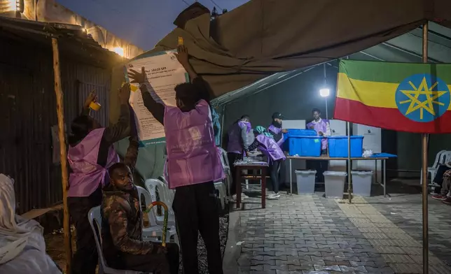 Election officials prepare a polling station before voting begins in the general election in Addis Ababa, Ethiopia, Monday, June 1, 2026. (AP Photo/Amanuel Sileshi)