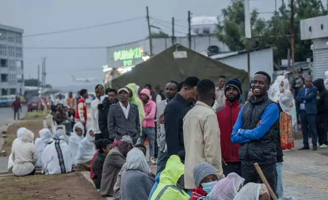 People gather outside a polling station before casting their votes in the general election in Addis Ababa, Ethiopia, Monday, June 1, 2026. (AP Photo/Amanuel Sileshi)