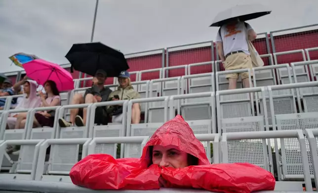 Fans wait for the start of the singles final match between United States' Jessica Pegula and Czech Republic's Linda Noskova at the WTA 500 Berlin Open tennis tournament which has been interrupted due to heavy rain in Berlin, Germany, Sunday, June 21, 2026. (AP Photo/Ebrahim Noroozi)