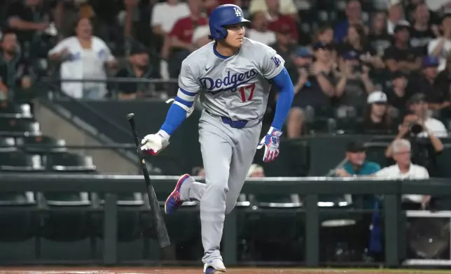 Los Angeles Dodgers' Shohei Ohtani (17) hits a single against the Arizona Diamondbacks in the first inning of a baseball game, Wednesday, June 3, 2026, in Phoenix. (AP Photo/Rick Scuteri)