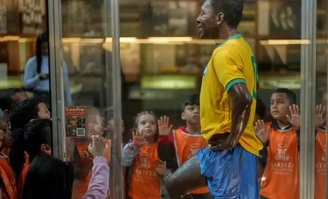 Children visit the Pele Museum in Santos, Brazil, Thursday, May 28, 2026. (AP Photo/Andre Penner)