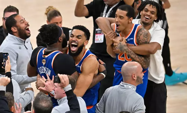 New York Knicks center Karl-Anthony Towns, right, hugs forward Og Anunoby during the after defeating the San Antonio Spurs in Game 5 of the NBA Finals basketball series, Saturday, June 13, 2026, in San Antonio. (AP Photo/Darren Abate)