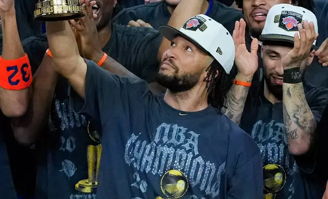 New York Knicks guard Jalen Brunson holds the MVP trophy after the Knicks defeated the San Antonio Spurs in Game 5 of the NBA Finals basketball series, Saturday, June 13, 2026, in San Antonio. (AP Photo/Ross D. Franklin)