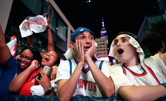 New York Knicks fans react after winning Game 5 of the NBA Finals basketball series against the San Antonio Spurs, Saturday, June 13, 2026, in New York. (AP Photo/Heather Khalifa)