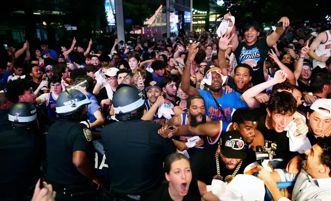 New York Knicks fans celebrate their victory after a watch party for Game 5 of the NBA Finals basketball series against the San Antonio Spurs, Saturday, June 13, 2026, in New York. (AP Photo/Heather Khalifa)