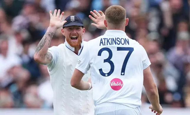 England's Gus Atkinson, right, celebrates with captain Ben Stokes after bowling out New Zealand's Matt Henry to win the Test match between England and New Zealand at Lord's cricket ground in London, Sunday, June 7, 2026. (AP Photo/Kirsty Wigglesworth)