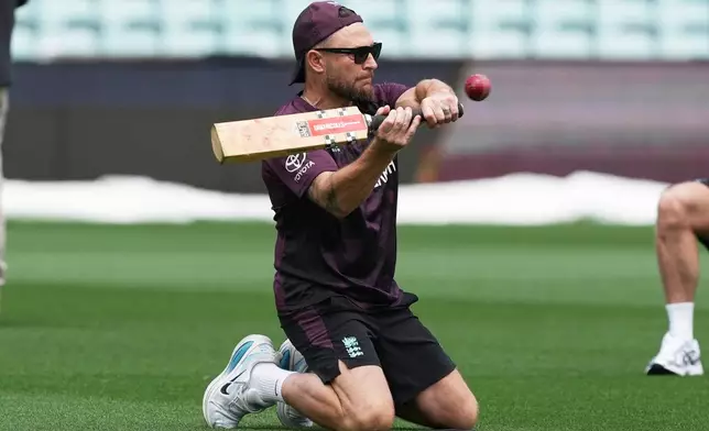 FILE -England coach Brendon McCullum hits the ball to England fielders during a practice session ahead of the fifth and final Ashes cricket test between England and Australia in Sydney, Australia, Jan. 2, 2026. (AP Photo/Mark Baker, File)