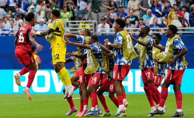 Cape Verde's Kevin Pina, left, celebrates with teammates after scoring his team's first goal during the World Cup Group H soccer match between Uruguay and Cape Verde in Miami Gardens, Fla., Sunday, June 21, 2026. (AP Photo/Rebecca Blackwell)